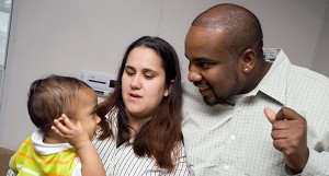 Injuries: Mom and dad smiling at baby it the doctor's office